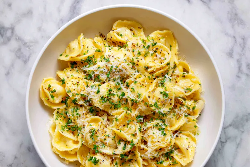 Cooking garlic butter pasta in a skillet