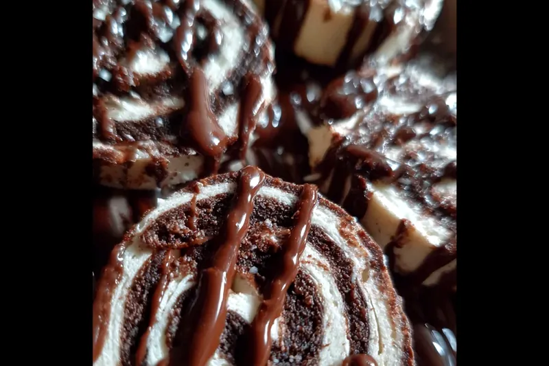 Organized ingredients for chocolate marshmallow cookies including cocoa powder, flour, butter, sugars, eggs, mini marshmallows, chocolate chips, and marshmallow fluff arranged on a marble counter