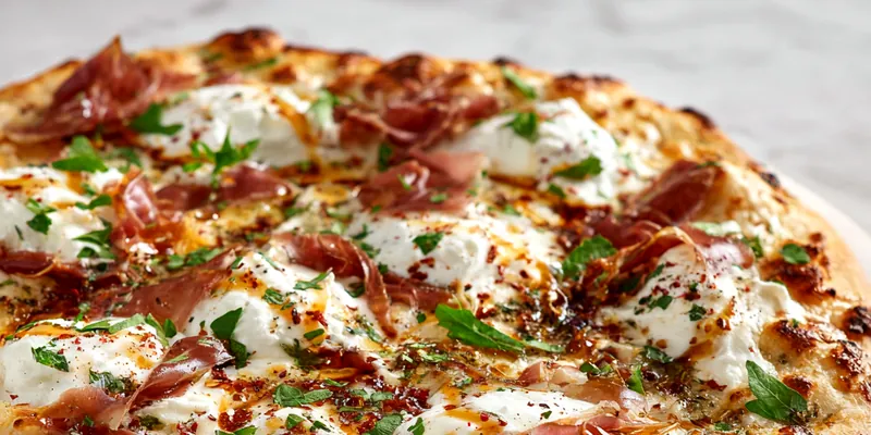 Freshly baked Prosciutto and Honey Burrata Pizza with arugula