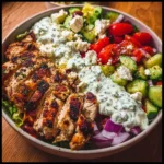 Delicious Greek Chicken Bowl with fresh vegetables and flavorful dressing