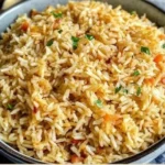 Delicious homemade rice pilaf garnished with herbs and vegetables