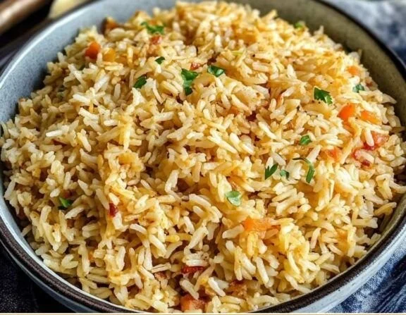 Delicious homemade rice pilaf garnished with herbs and vegetables