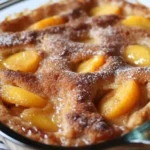 Delicious homemade peach cobbler served with vanilla ice cream