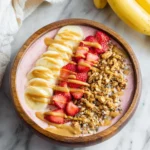 Colorful smoothie bowl topped with fresh fruits and seeds for a nutritious meal.