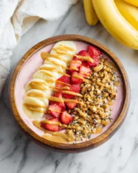 Colorful smoothie bowl topped with fresh fruits and seeds for a nutritious meal.