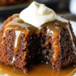 Delicious sticky toffee pudding cake topped with warm caramel sauce and cream