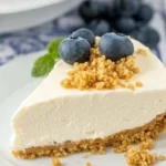 Delicious no-bake cheesecake topped with fresh berries on a white plate
