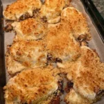 Baked chicken with Parmesan and mayo, golden and crispy on a plate.