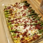 Delicious cheesy baked asparagus with bacon served on a plate