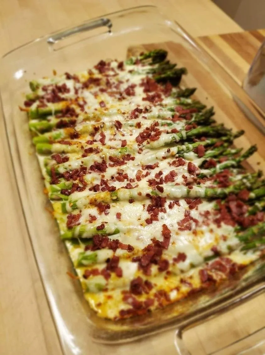 Delicious cheesy baked asparagus with bacon served on a plate