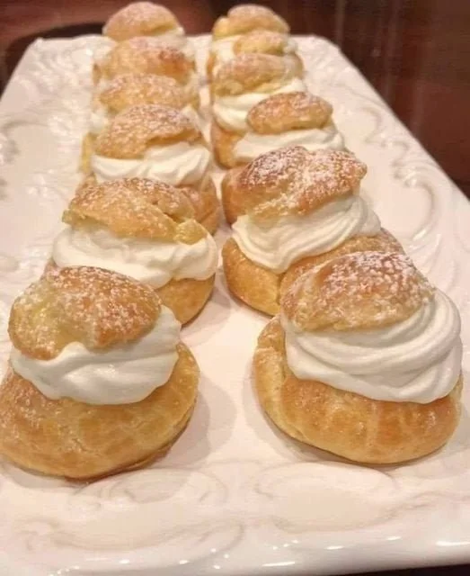 Delicious cream puffs filled with creamy vanilla filling, perfect for desserts.