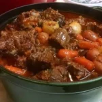 A bowl of delicious beef stew with vegetables and herbs