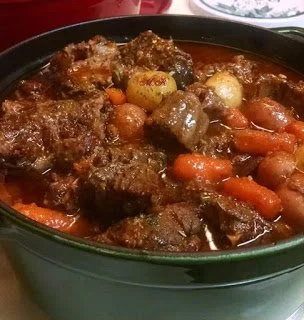 A bowl of delicious beef stew with vegetables and herbs