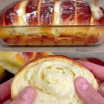 Freshly baked fluffy condensed milk bread loaf on a wooden surface