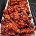 Deliciously grilled chicken wings garnished with herbs and spices