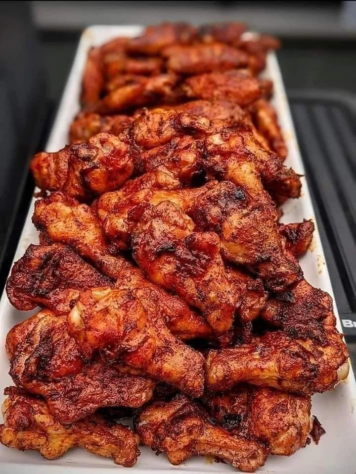 Deliciously grilled chicken wings garnished with herbs and spices