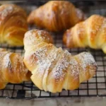 Freshly baked Italian Croissants on a wooden table