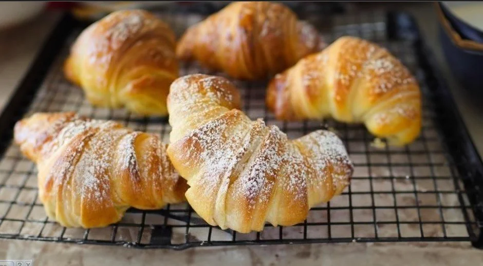 Freshly baked Italian Croissants on a wooden table