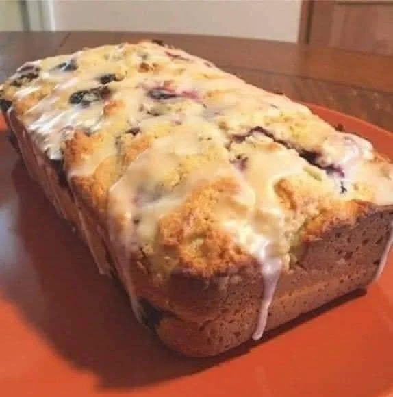 Freshly baked lemon blueberry bread loaf with vibrant blueberries and lemon zest