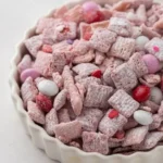 A bowl of homemade Muddy Buddies snack mix with chocolate and peanut butter
