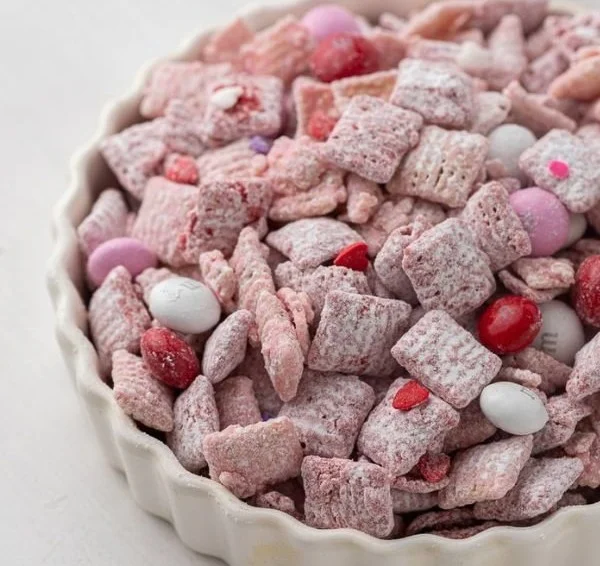 A bowl of homemade Muddy Buddies snack mix with chocolate and peanut butter