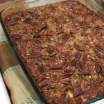 Delicious homemade pecan pie bars topped with nuts and caramel, ideal for dessert.