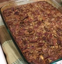Delicious homemade pecan pie bars topped with nuts and caramel, ideal for dessert.