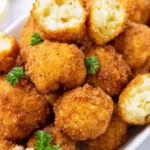 Cheesy mac and cheese bites served on a platter