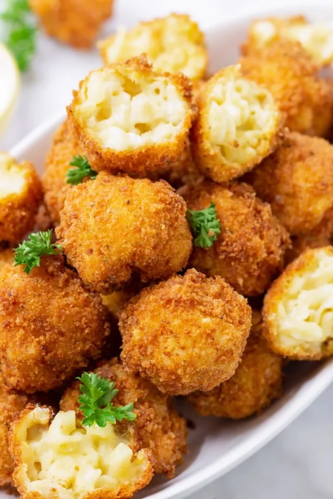 Cheesy mac and cheese bites served on a platter
