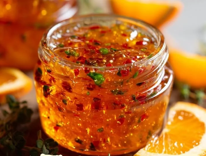 Homemade Citrus Jelly in a jar with fresh citrus fruits