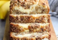 Cream Cheese Banana Bread with Crumb Topping on a wooden cutting board
