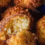 Golden brown homemade hush puppies served on a plate