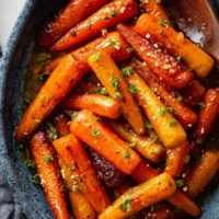 Roasted brown butter honey garlic carrots garnished and ready to serve
