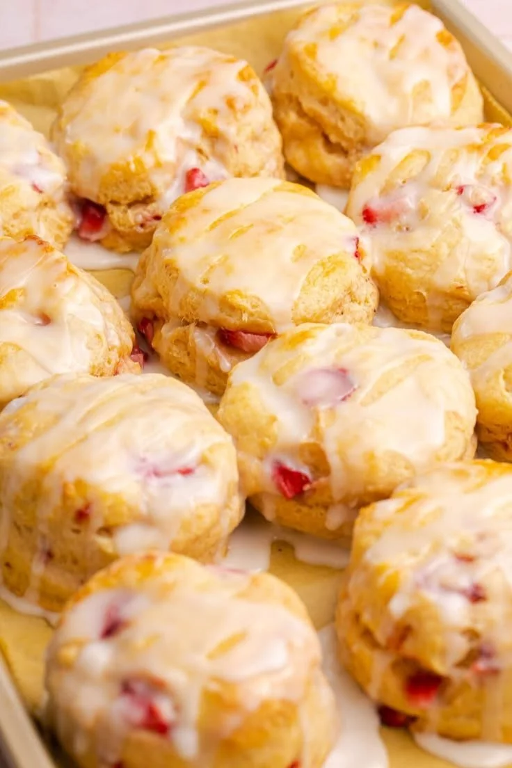 Freshly baked strawberry biscuits with a golden crust and ripe strawberries