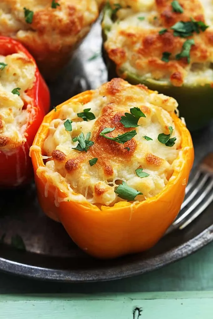 Three cheese macaroni stuffed peppers garnished and ready to serve