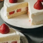 Slice of Japanese Strawberry Cake decorated with fresh strawberries and whipped cream