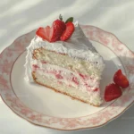 Strawberry Swirled White Chocolate Cake with fresh strawberries and creamy frosting