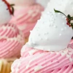 White chocolate covered strawberry cupcakes on a decorative plate