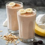 A colorful, nutritious morning smoothie in a glass topped with fresh fruits and greens.