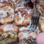 Big-batch cinnamon rolls recipe by Bonnie, featuring fluffy dough and sweet icing.