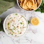 Bright lemon-infused whipped feta dip served in a bowl with fresh herbs