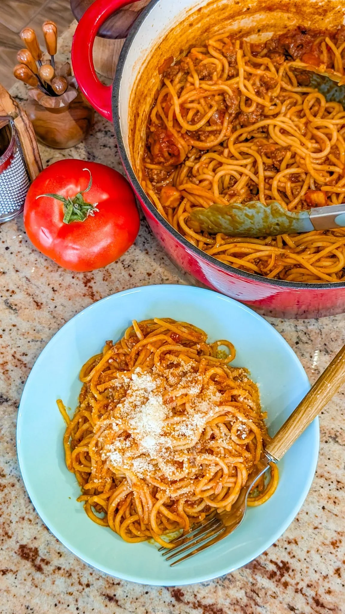Creamy slow cooker spaghetti bolognese served in a bowl with fresh herbs