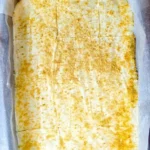 Delicious slice of Genuine Woolworth Cheesecake topped with whipped cream.