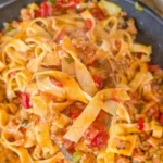 Italian-style drunken noodles with fresh ingredients and vibrant colors