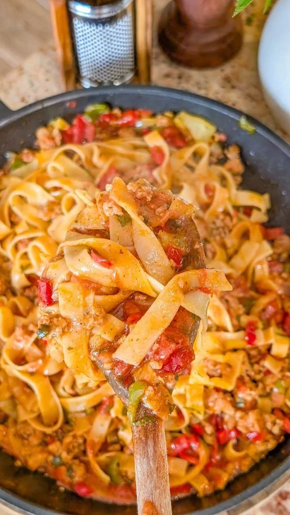 Italian-style drunken noodles with fresh ingredients and vibrant colors