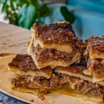 Pecan Pie-Style Cobbler topped with pecans and caramel sauce