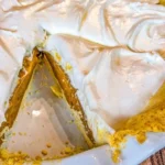 Delicious silky butterscotch pie sliced and garnished on a dessert plate