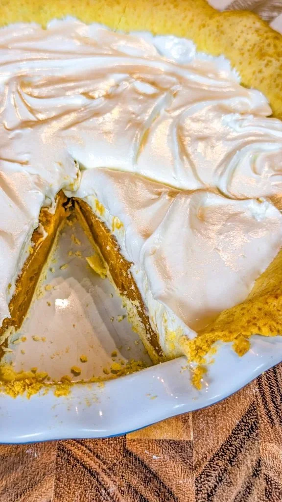 Delicious silky butterscotch pie sliced and garnished on a dessert plate
