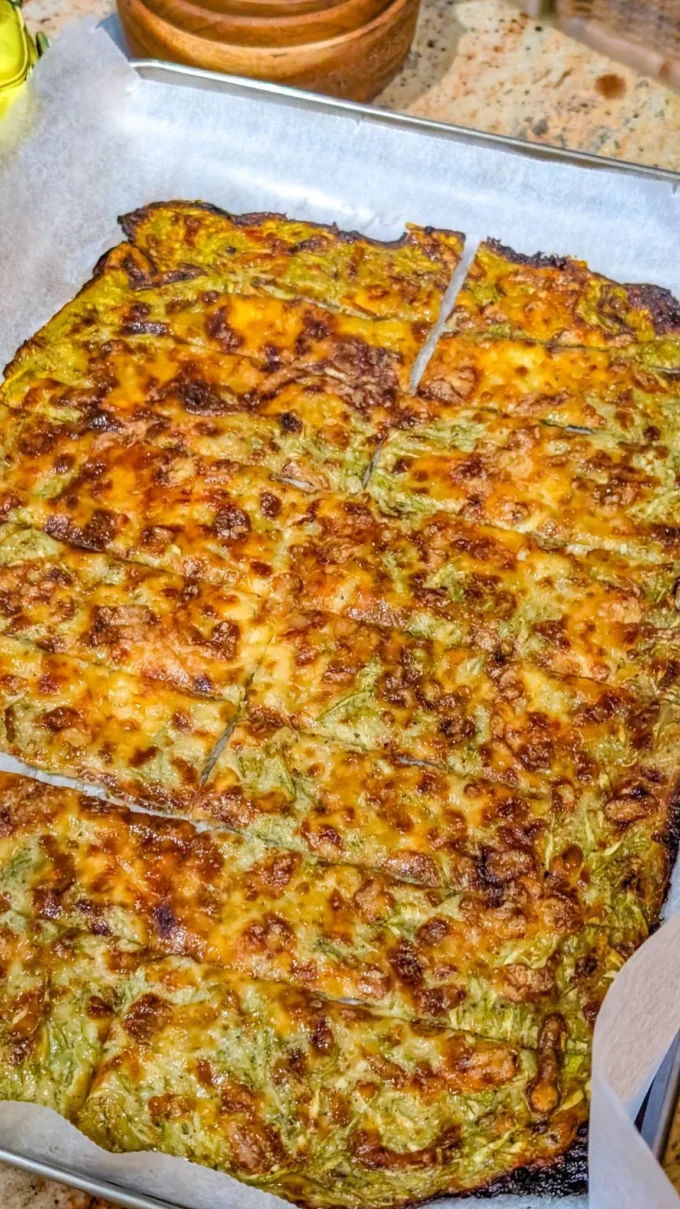 Cheesy zucchini breadsticks served with marinara sauce on a plate