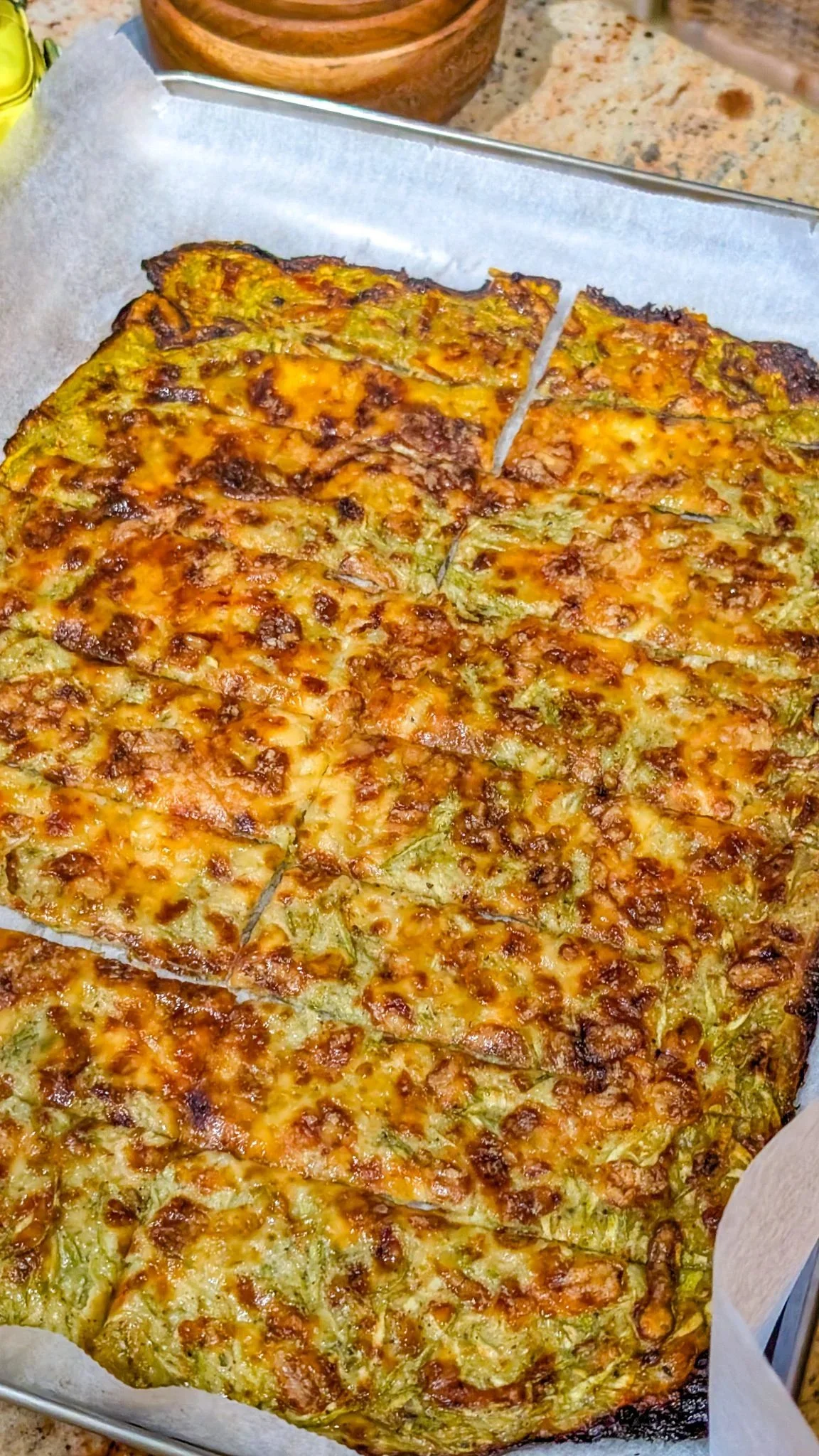 Cheesy zucchini breadsticks served with marinara sauce on a plate
